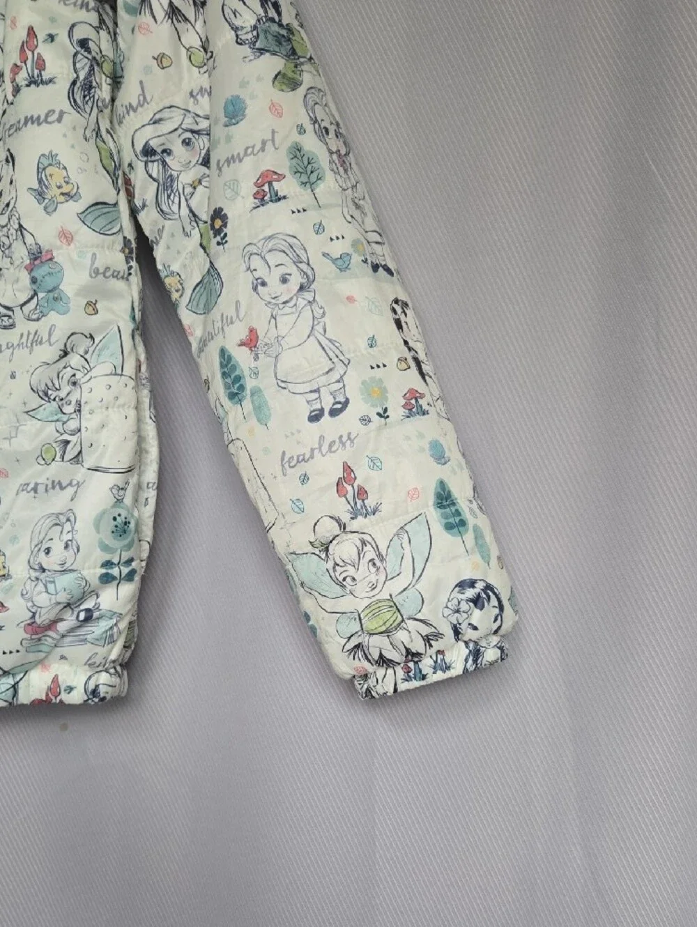 Disney Quilted Puffer Jacket with Cream Background and Pastel Accents